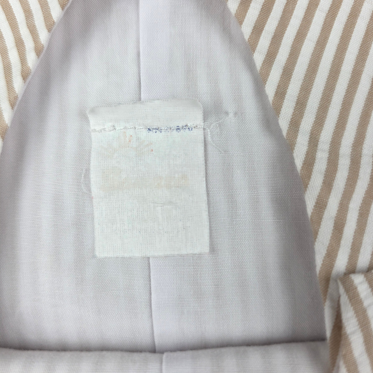 Back of striped shortall with buttoned tabs