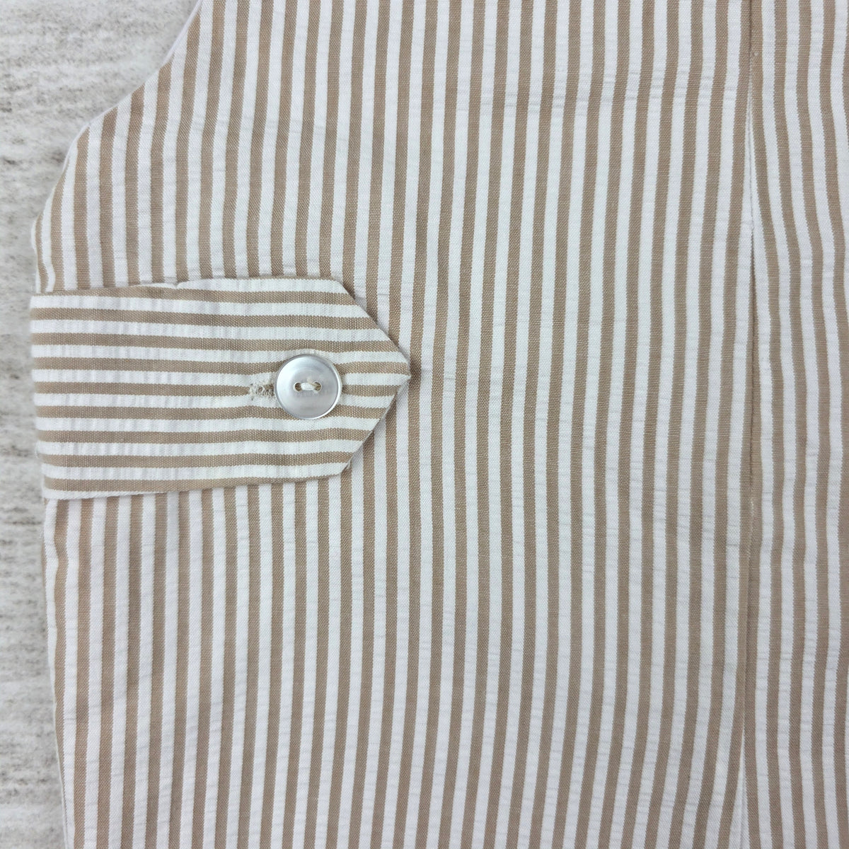 Back tab button and striped fabric detail