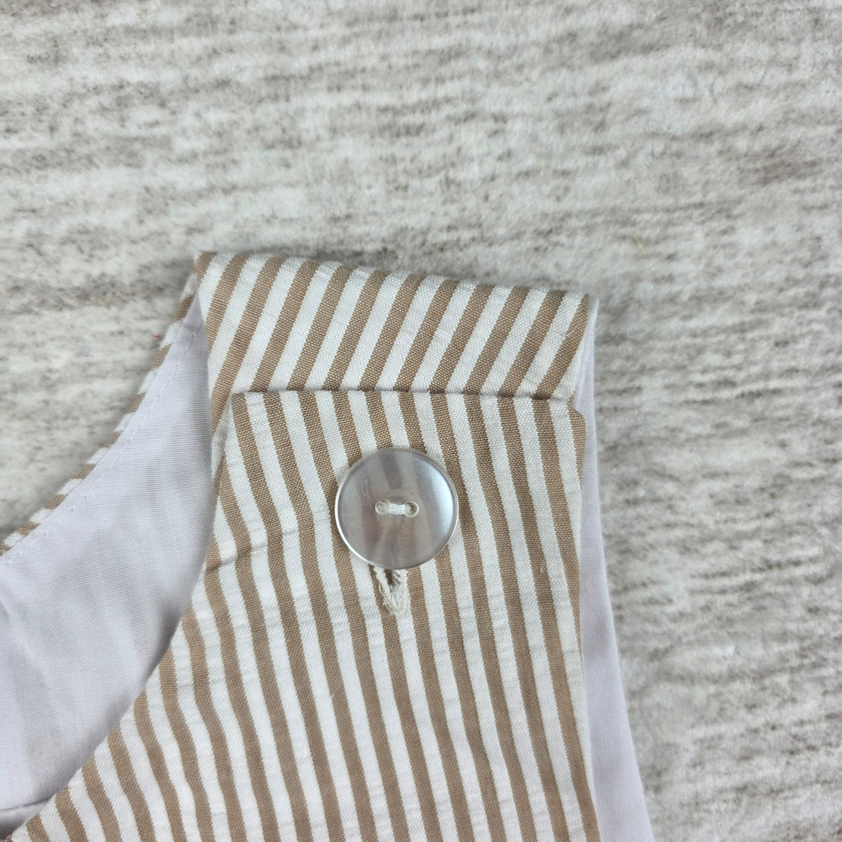 Front of tan and white striped cowboy appliqué shortall