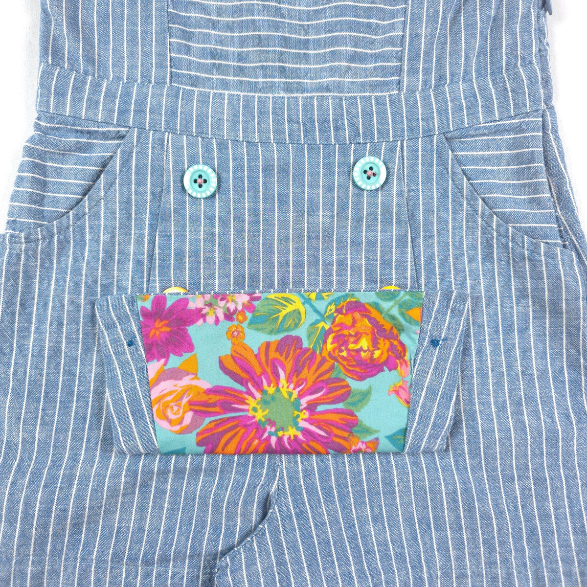 Bushel & Peck Children's Consignment Boutique blue pinstripe dress with floral pocket and decorative buttons