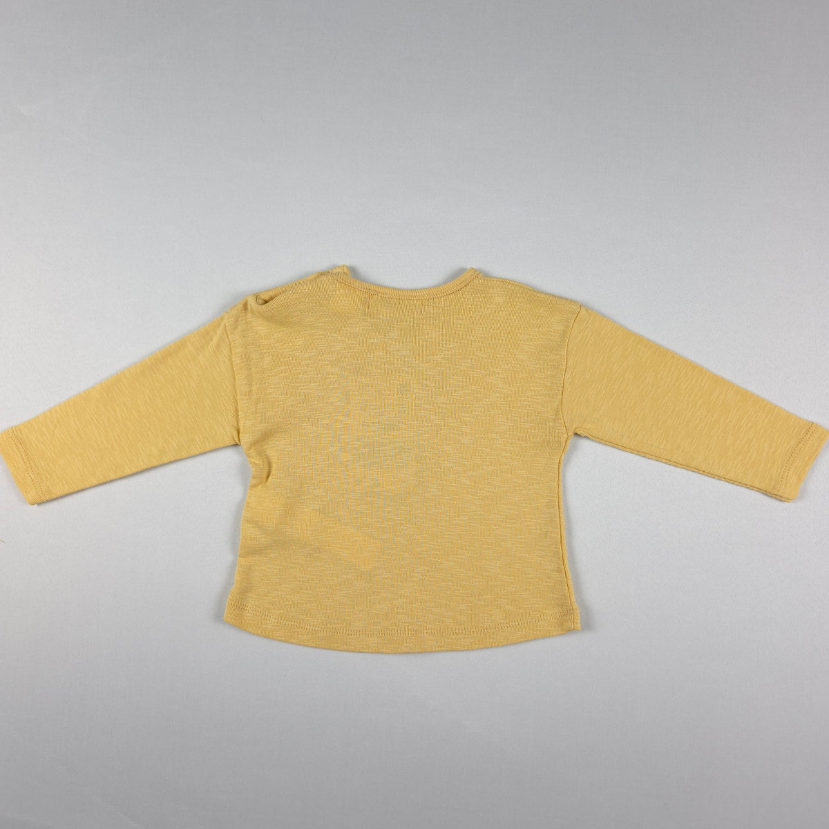 Bushel & Peck Children's Consignment Boutique Zara Baby golden yellow long sleeve cotton top, back view.